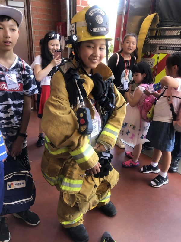 Young Student In Firefighter Outfit