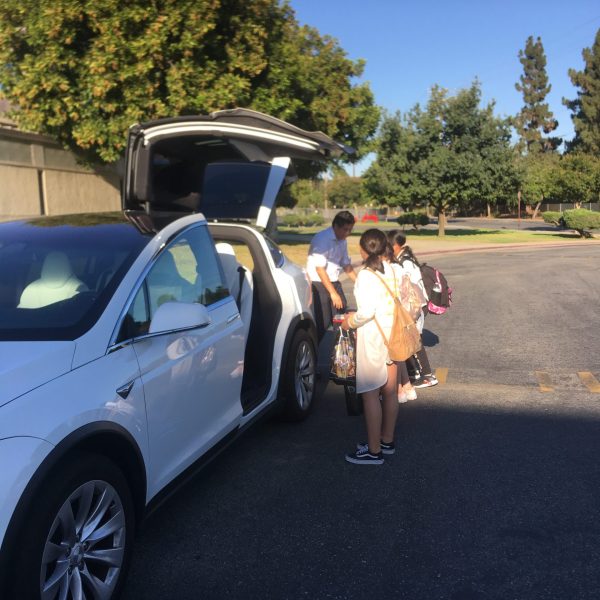 Students Getting Luggage in a Car