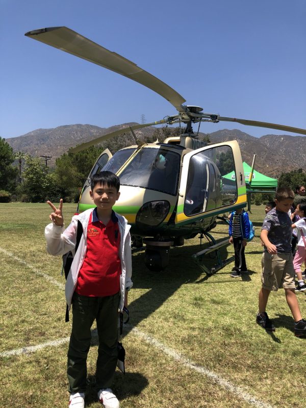 Young Boy In Front Of A Helicopter